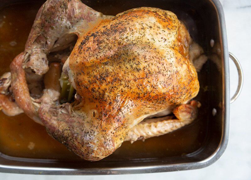 Oven Roast Turkey in a baking pan ready to be enjoy!