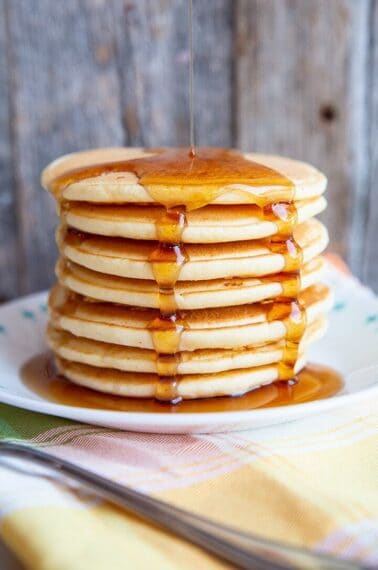 adding syrup on a stack of Bisquick® Pancakes
