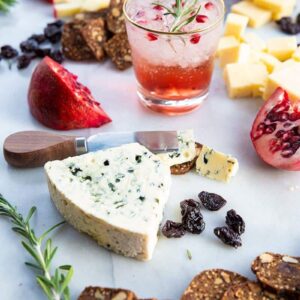 Perfect Cheeseboard with the other food items and a glass of Pomegranate Gin Fizz