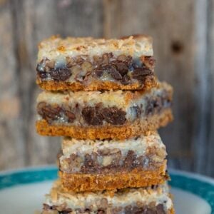 close up stack of Magic Cookie Bars in a dessert plate