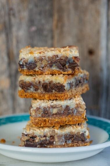 close up stack of Magic Cookie Bars in a dessert plate