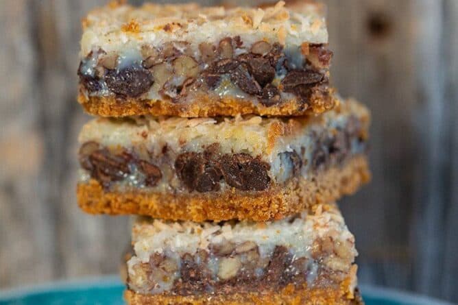 close up stack of Magic Cookie Bars in a dessert plate