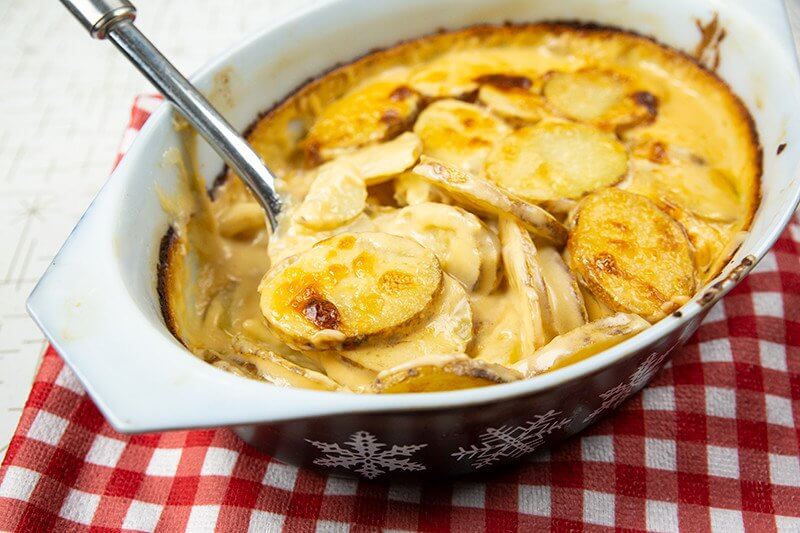 Creamy Cheesy Scalloped Potatoes in a casserole dish