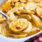 close up of Creamy Cheesy Scalloped Potatoes in a casserole dish