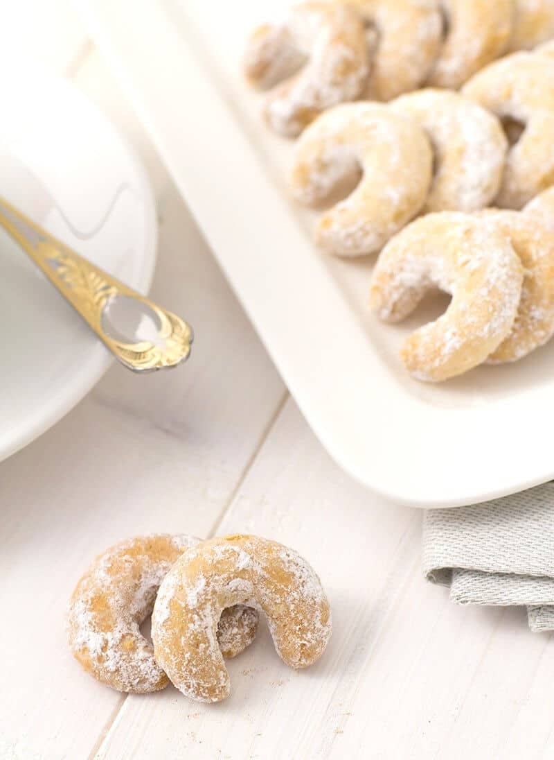 crescent shape Mexican Wedding Cookies rolled in confectioners sugar
