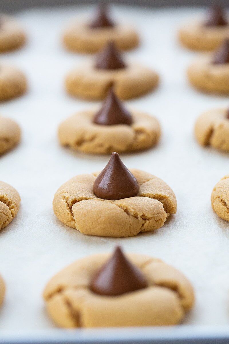 freshly baked cookies with unwrapped Hershey's kiss in the middle