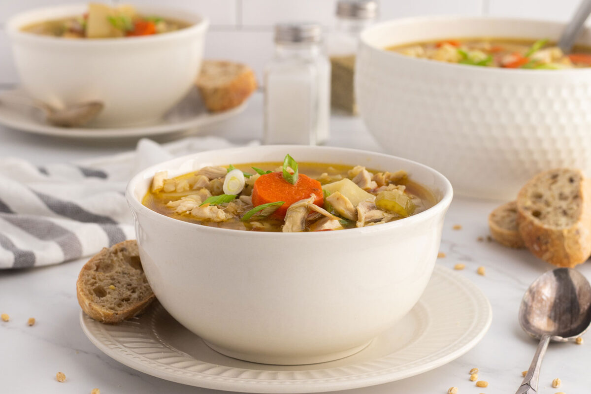 chicken barley soup in white bowl