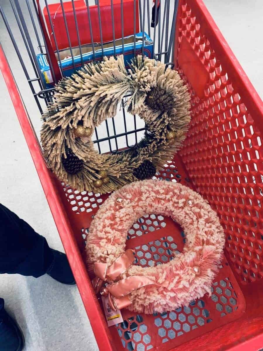 vintage bottle brush wire wreathes flocked with fake snow in a red push cart