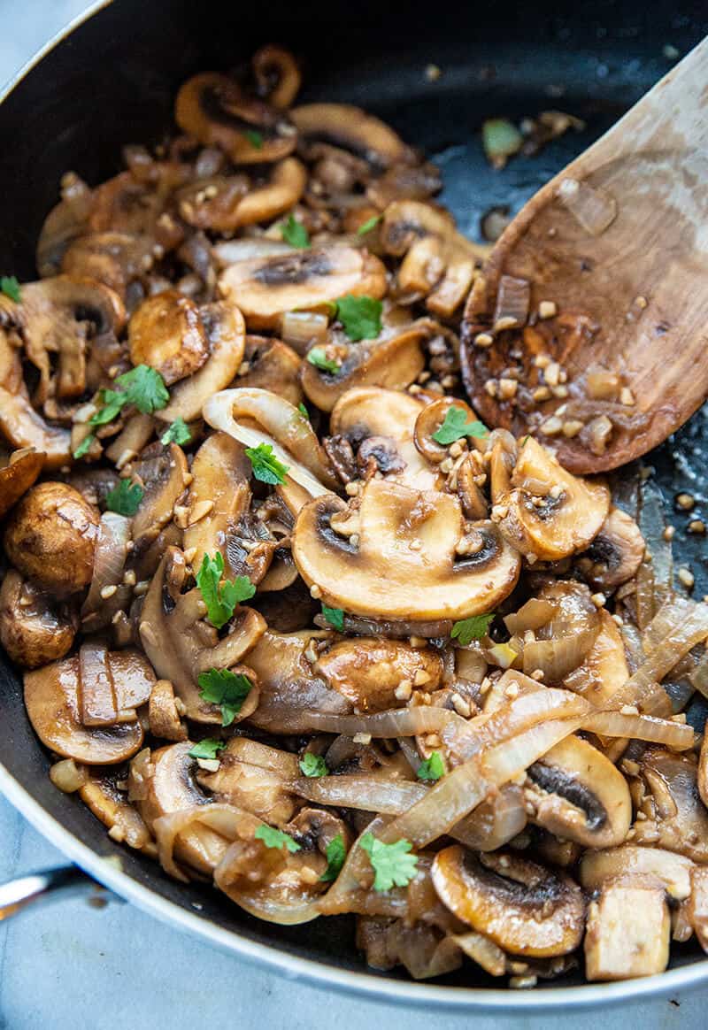 close up Sauteed Mushrooms and Onions in a large skillet 