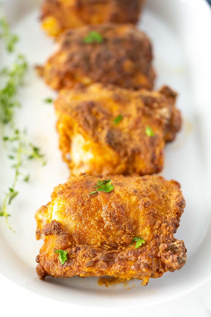 four stack of crispy-skinned air fryer chicken in white plate