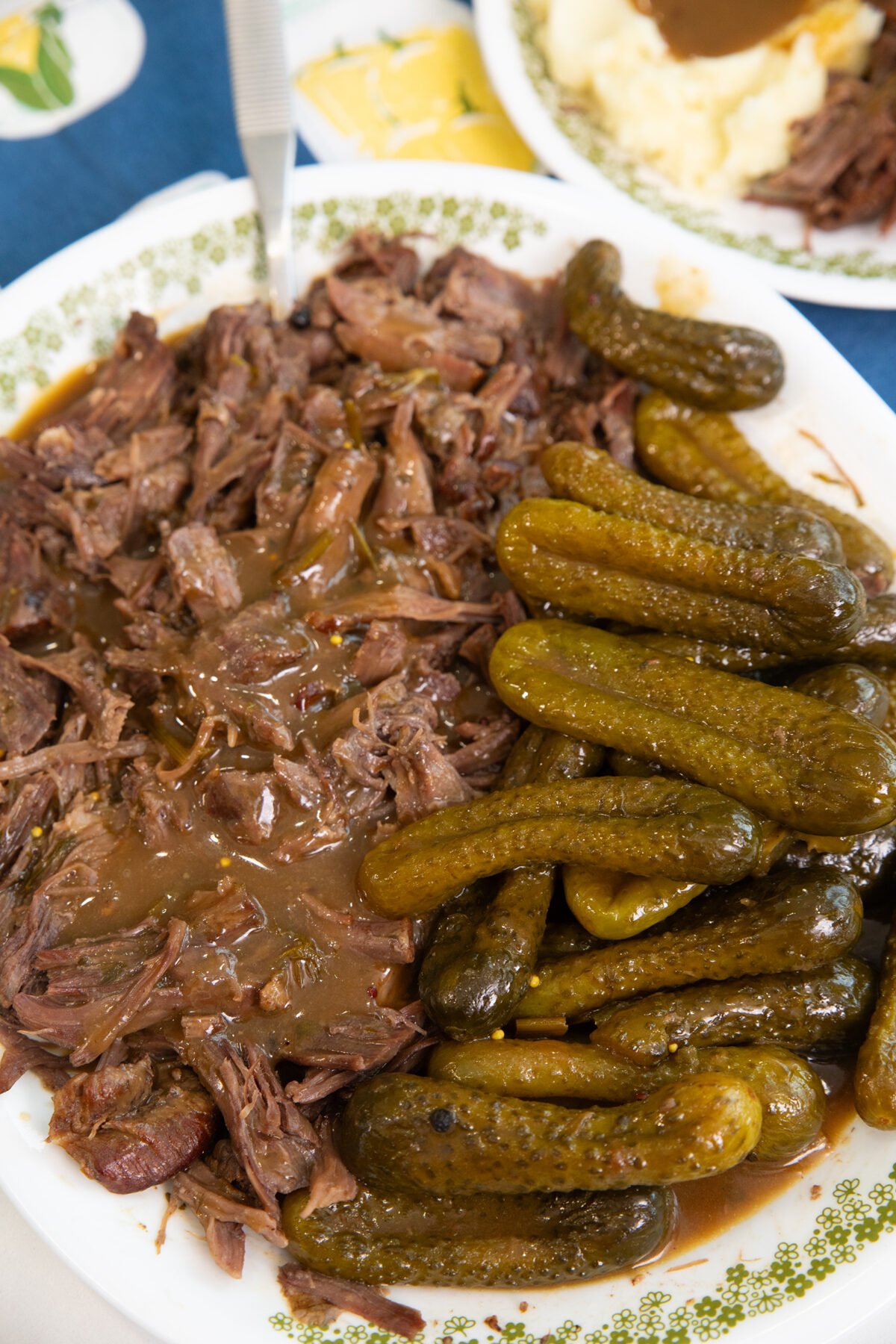 shredded dill pickle pot roast on a plate