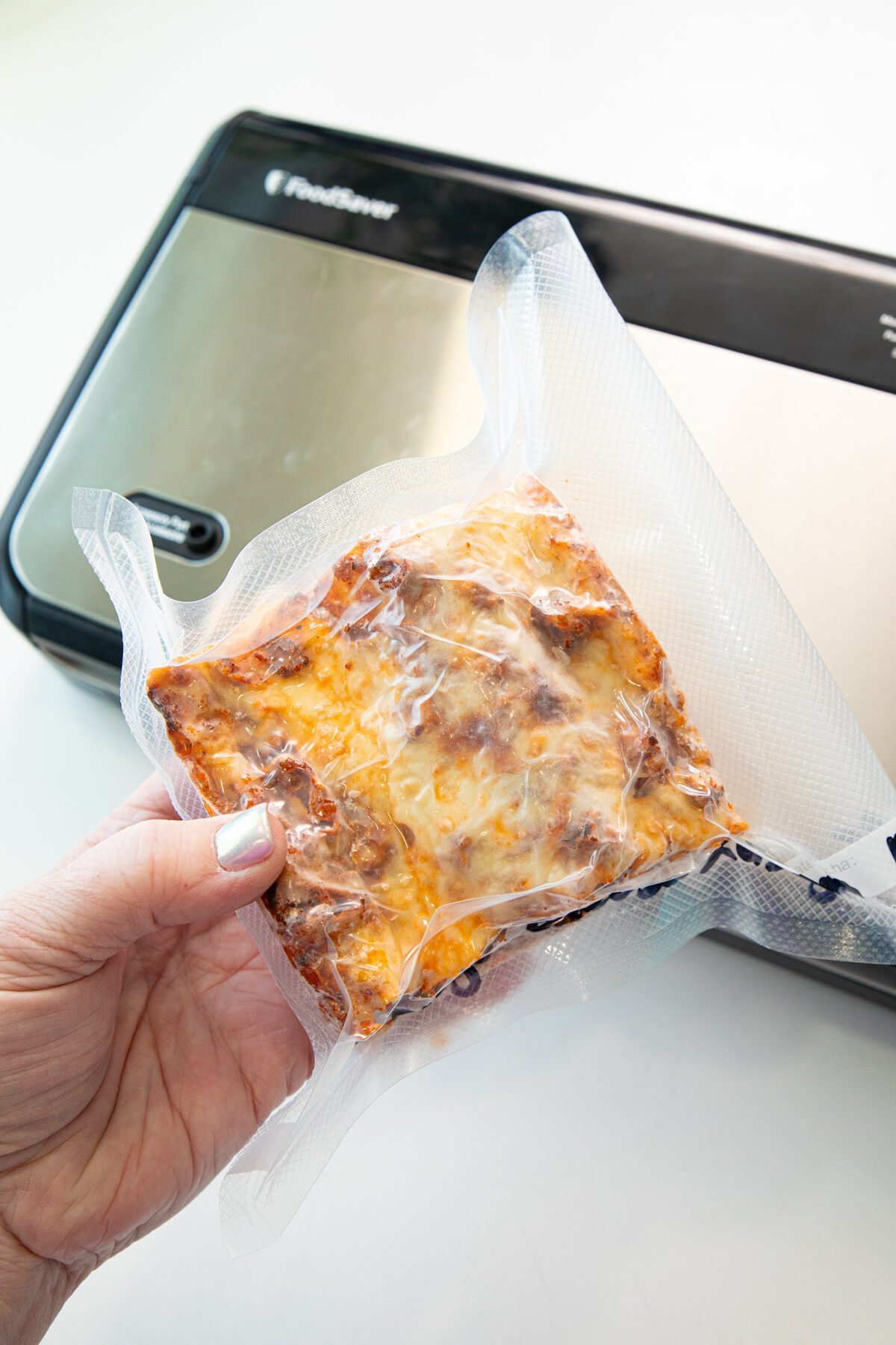 a piece of lasagna sealed in a freezer bag