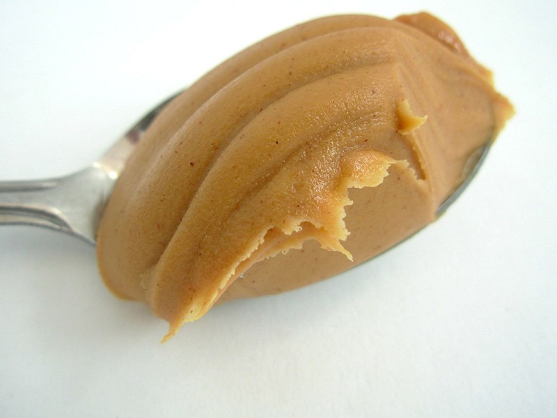 smooth peanut butter on a spoon
