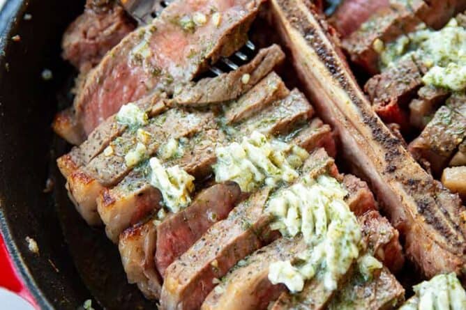 close up Skillet Porterhouse Steak with Garlic Dill Butter