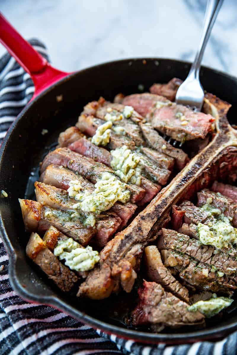 close up Skillet Porterhouse Steak with Garlic Dill Butter