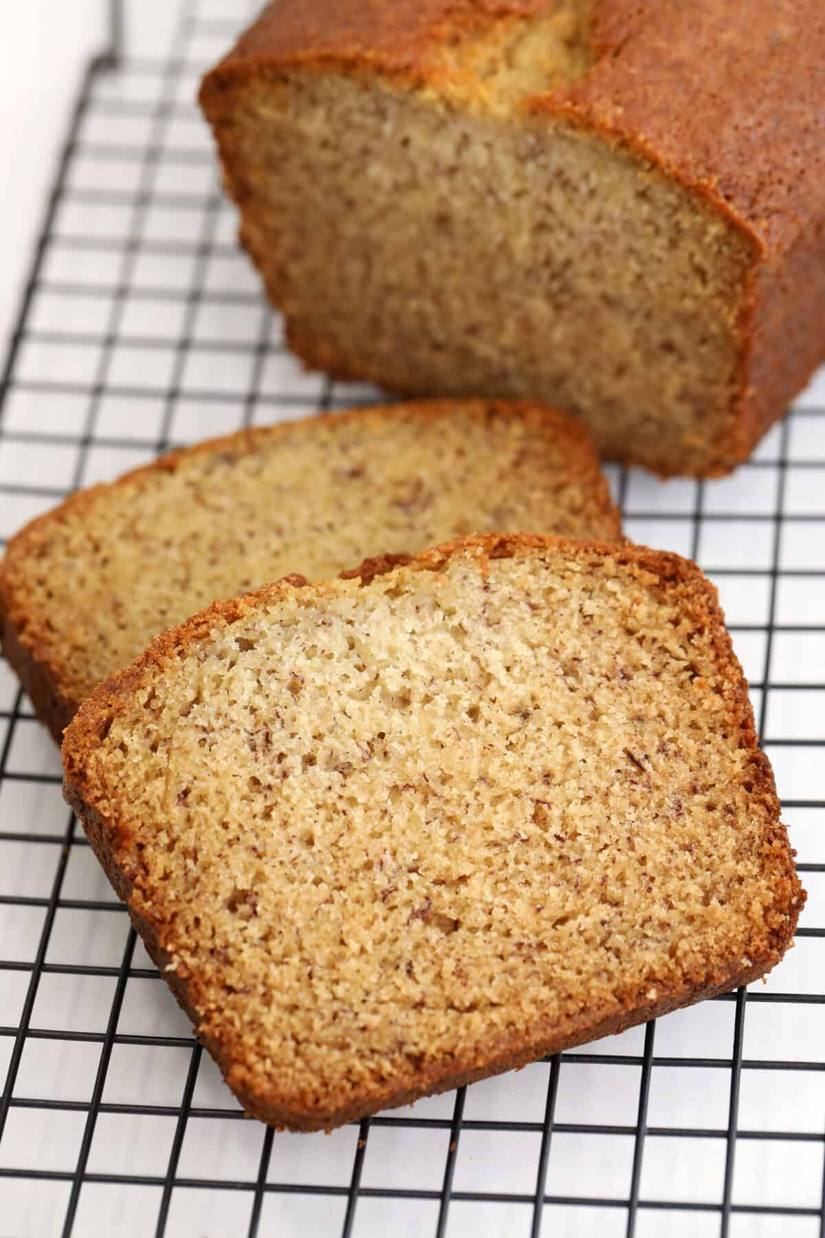 Buttermilk Banana Bread sliced on a black cooling rack