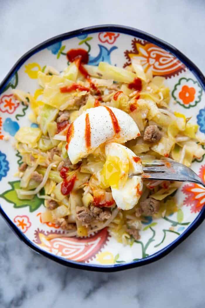 close up Egg Roll in a Bowl with poached egg on top