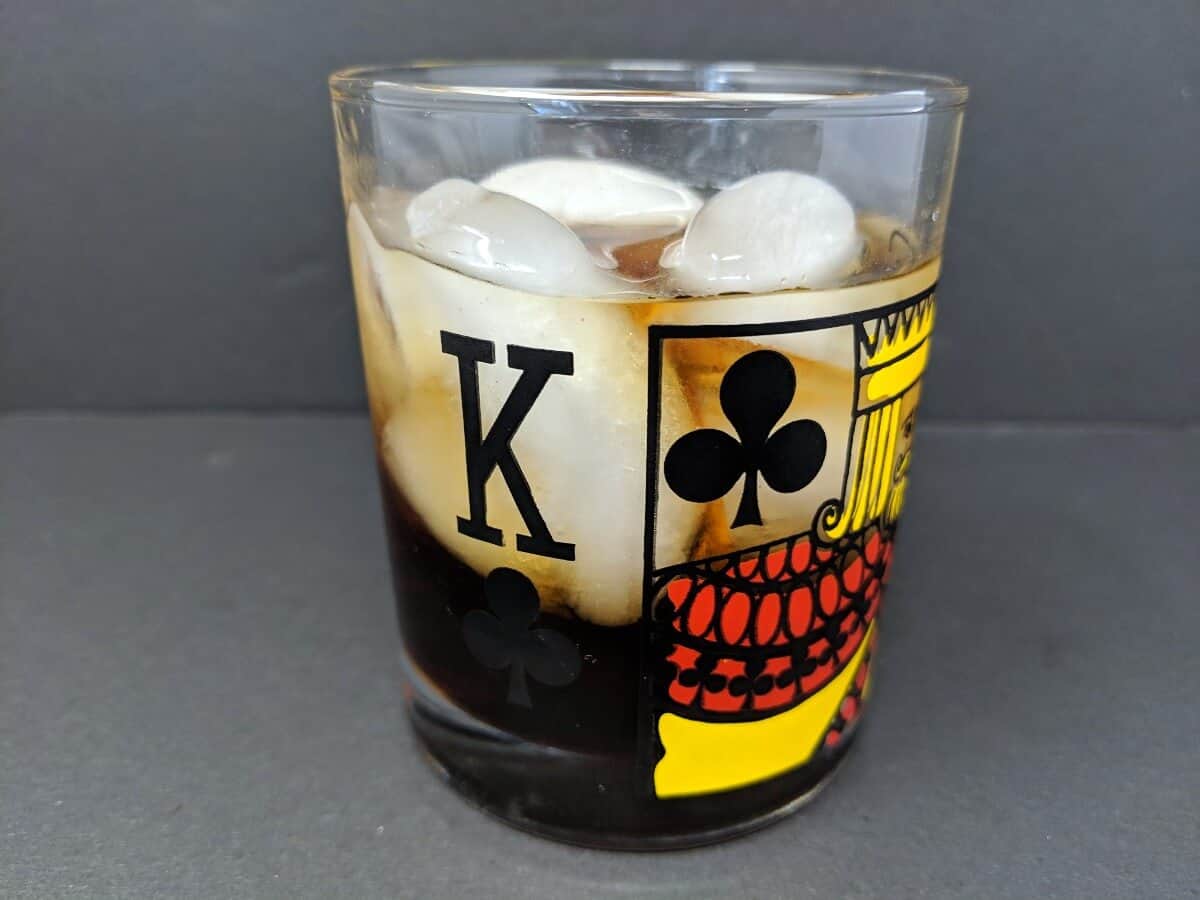 an old fashioned glass with ice and Black Russian drink