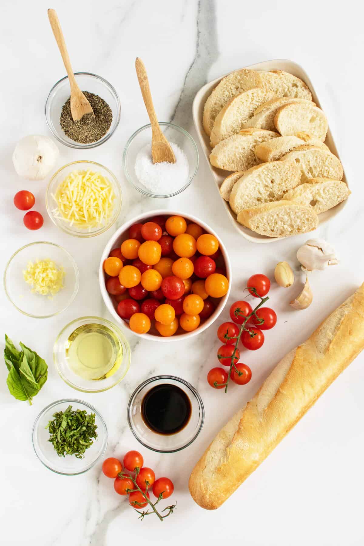 Bruschetta ingredients in small white and clear bowls