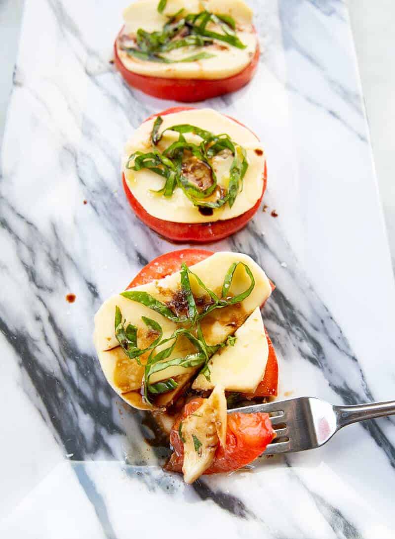 getting a small part of Caprese Salad using a fork