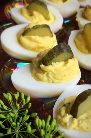 close up Dill Pickle Deviled Eggs garnish with slice of Dill Pickle