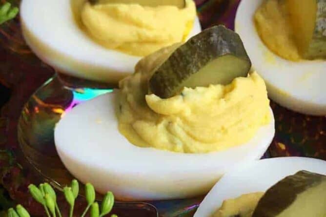 close up Dill Pickle Deviled Eggs garnish with slice of Dill Pickle