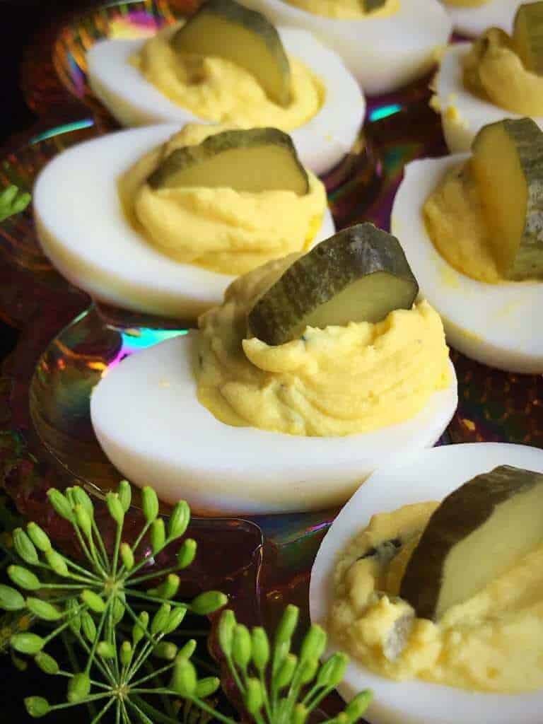 close up Dill Pickle Deviled Eggs garnish with slice of Dill Pickle