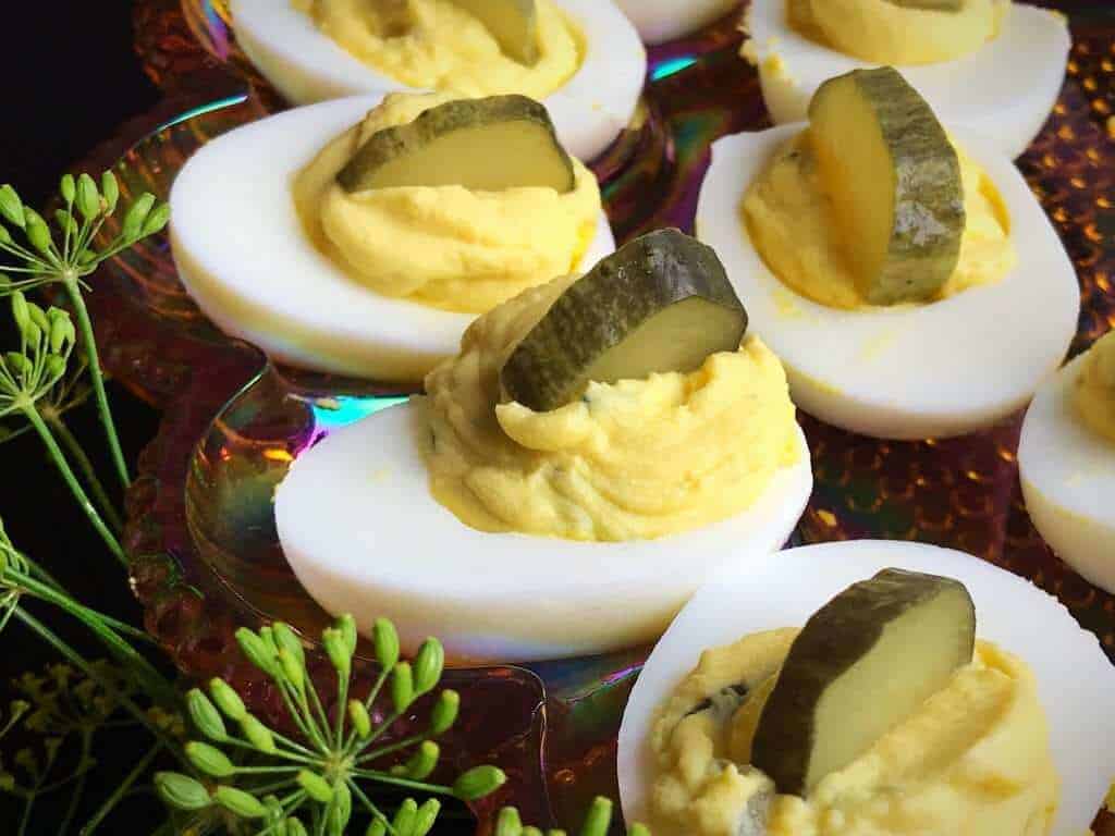 Dill Pickle Deviled Eggs garnish with slice of Dill Pickle