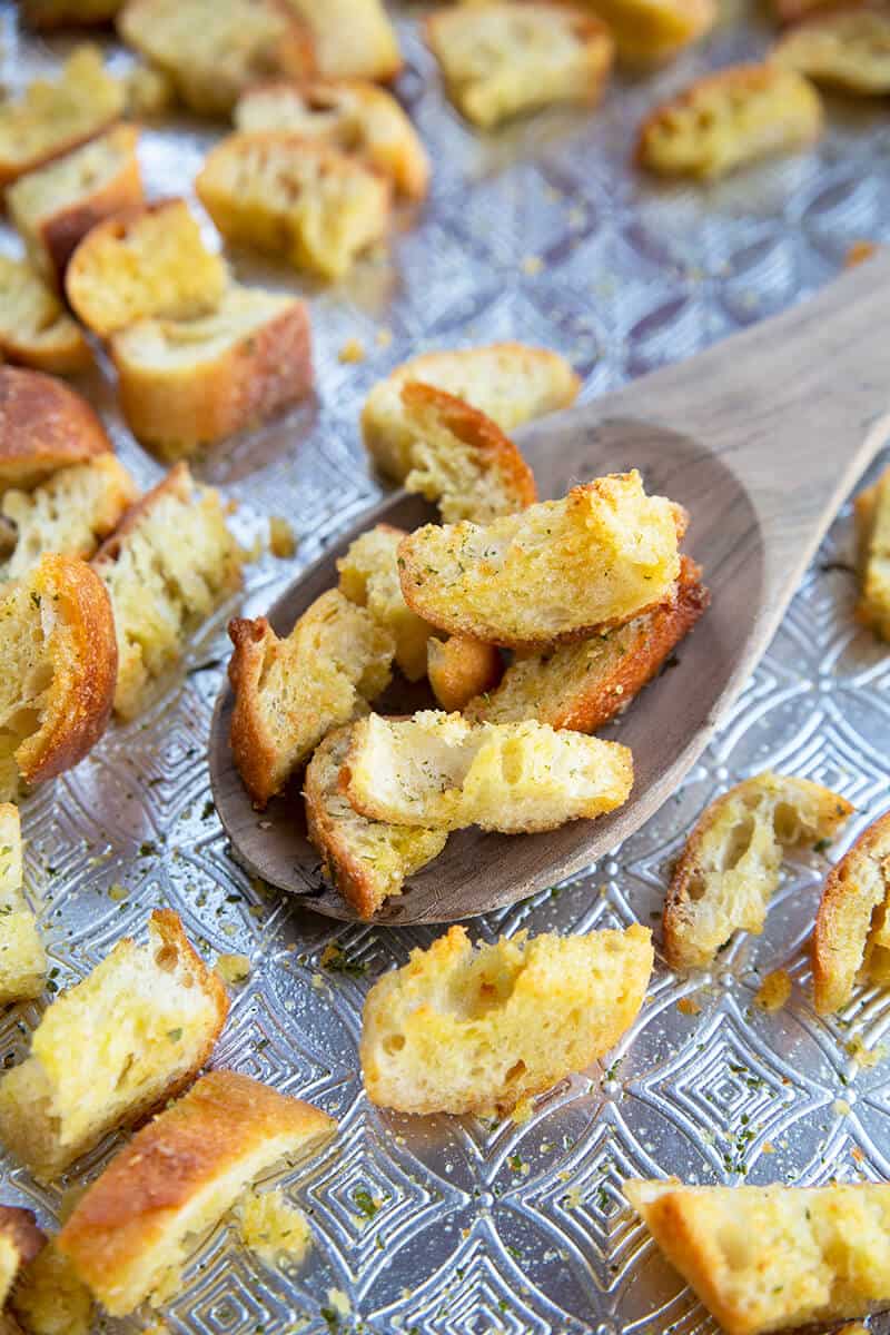 close up Wooden spoon with Buttery, Garlicky Homemade Croutons