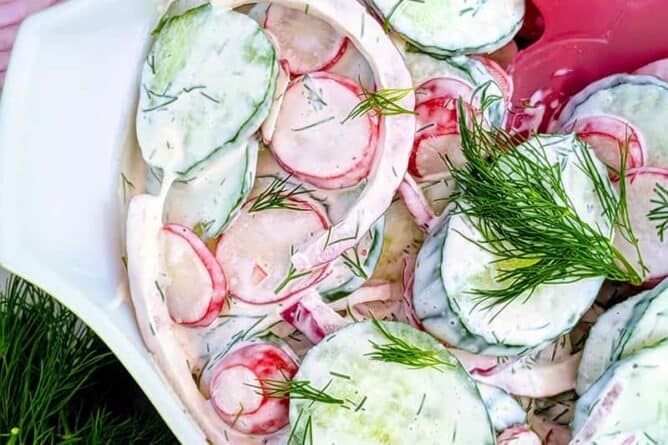 close up Dilled Creamy Cucumber Salad in medium-sized bowl with mayo based dressing