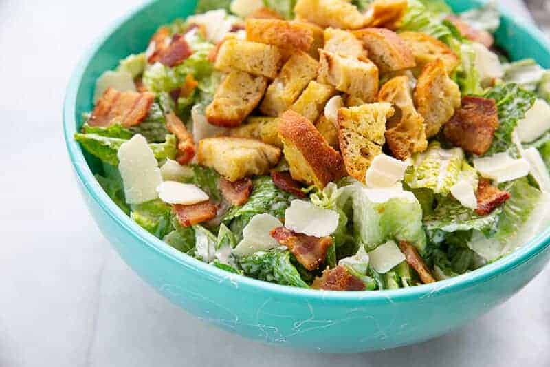 Homemade Classic Caesar Salad in a jade blue bowl