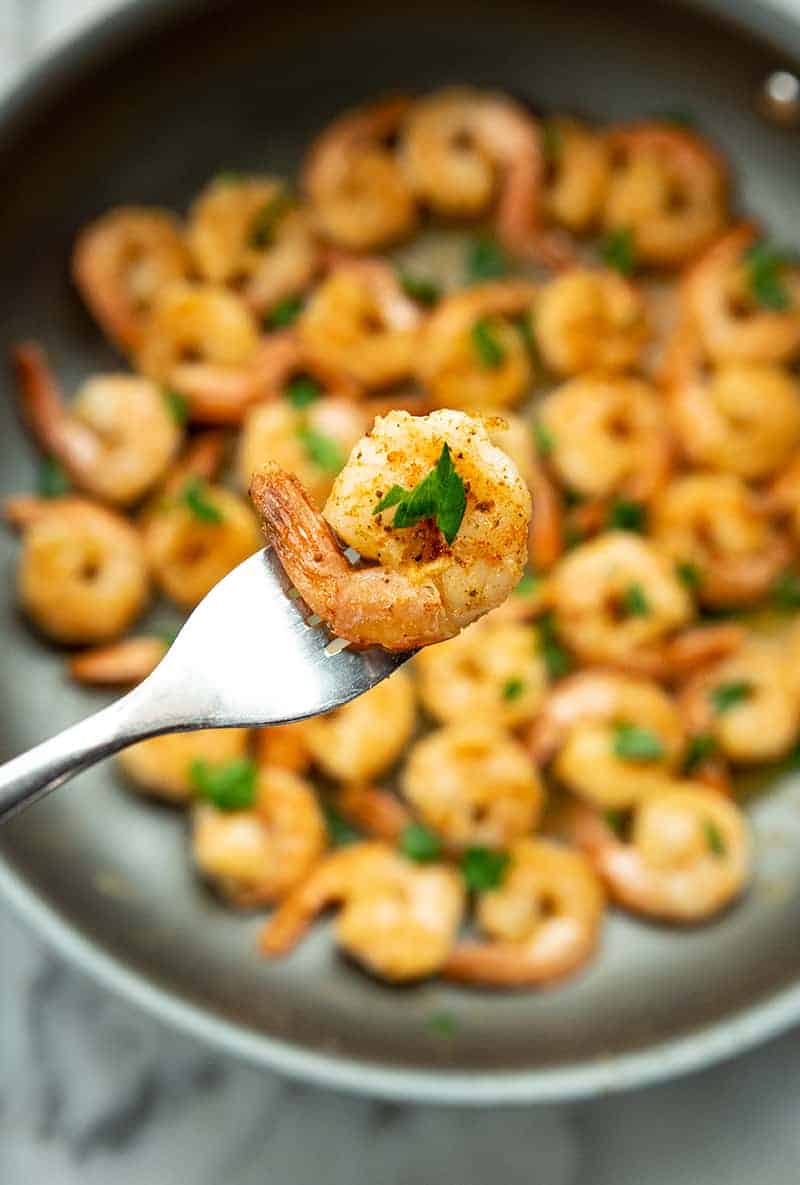 a piece of Buttery Old Bay Steamed Shrimp in a fork