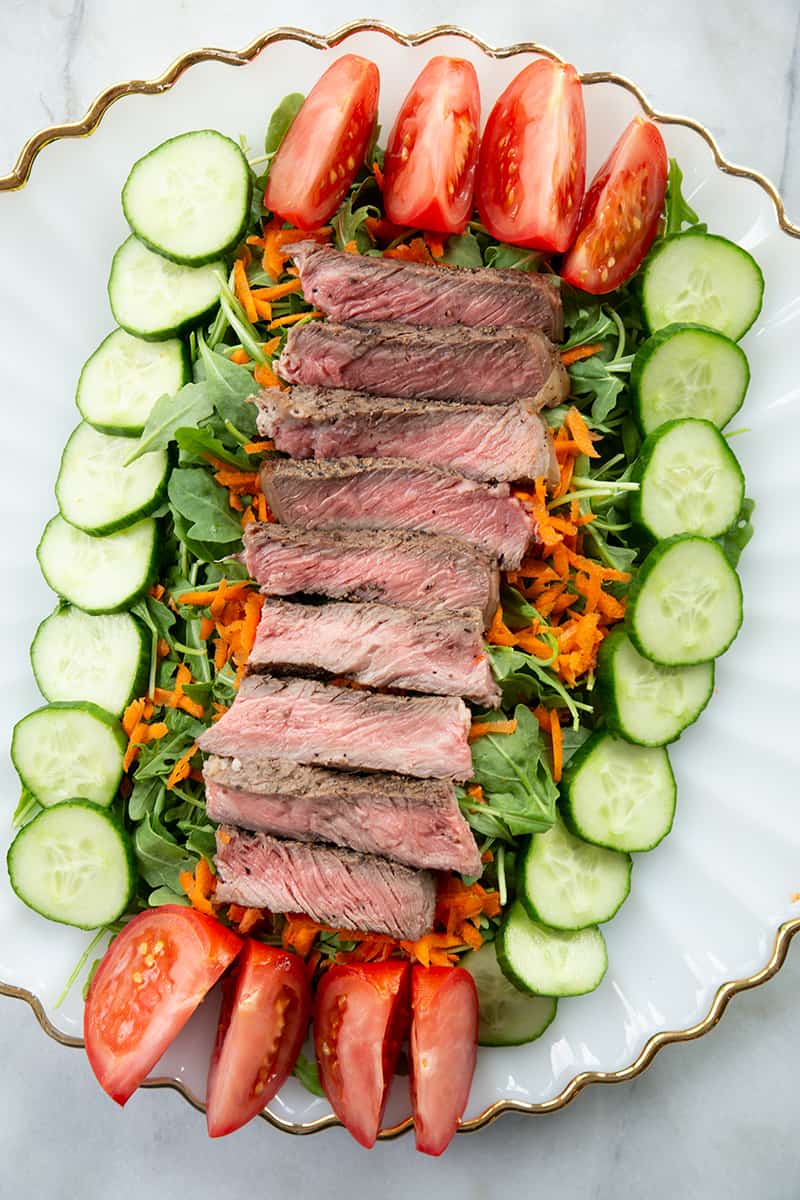 Asian Sesame Grilled Steak Salad in a white serving plate