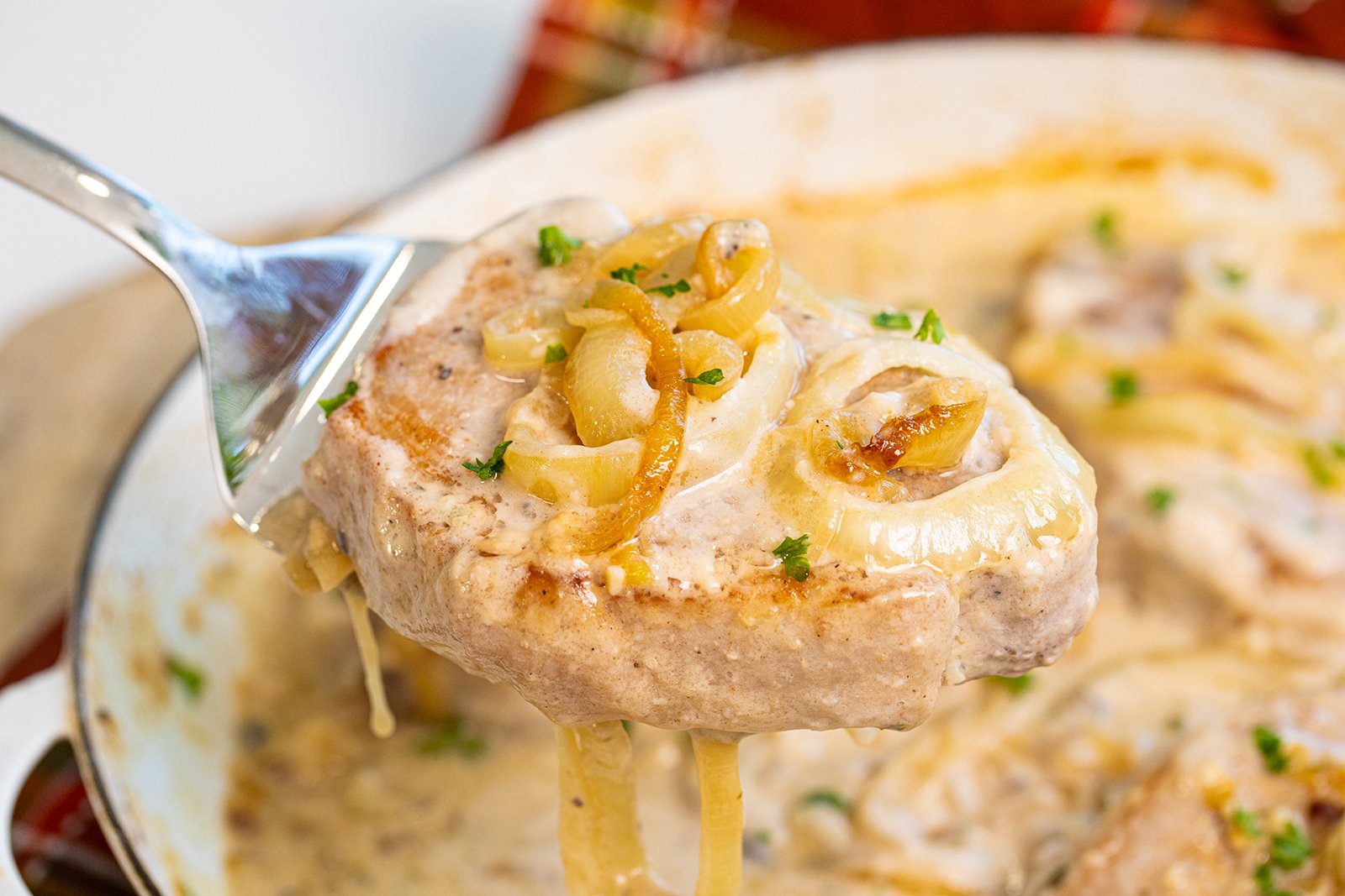 A plate with mushrooms, potatoes and a fork.