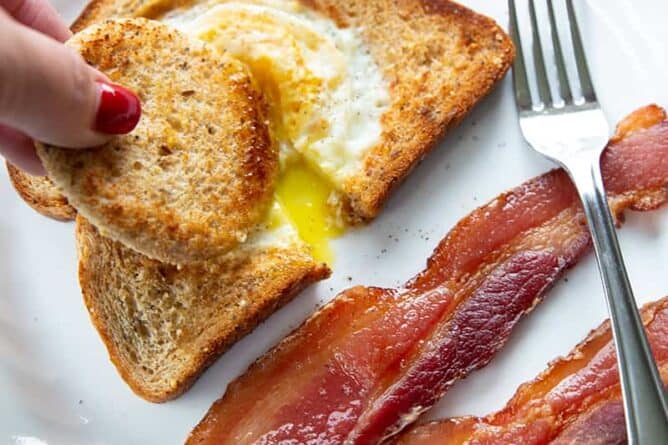 dipping toast into eggs in a basket