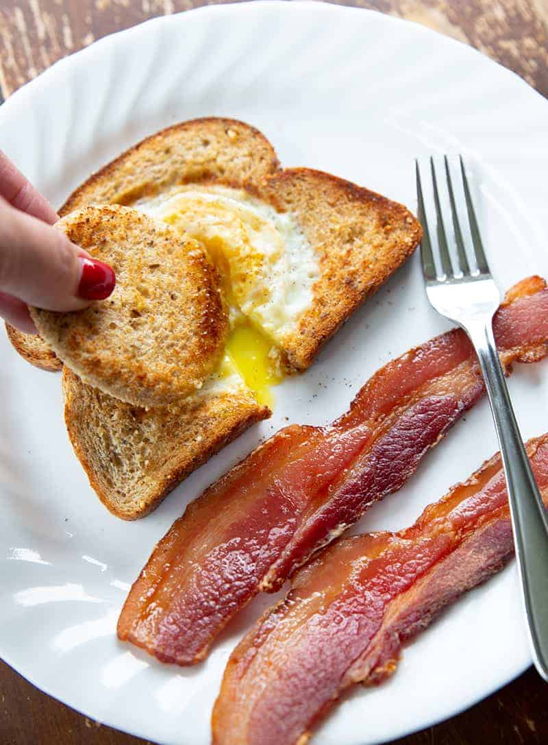 dipping toast into eggs in a basket