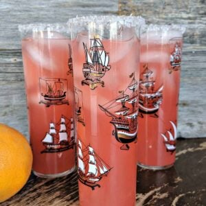 Close up of three Salty Dog cocktails against a wood background