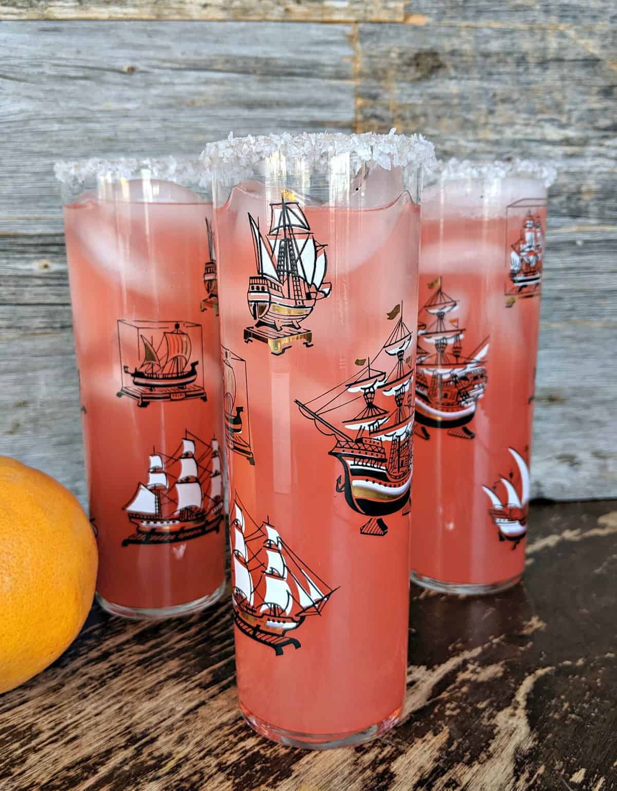 Close up of three Salty Dog cocktails against a wood background