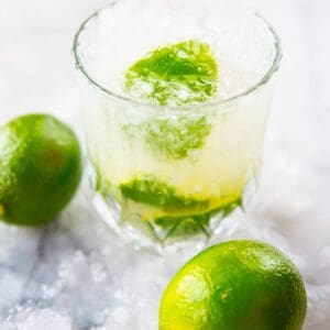 close up glass of Caipirinha with crushed ice, garnish with lime