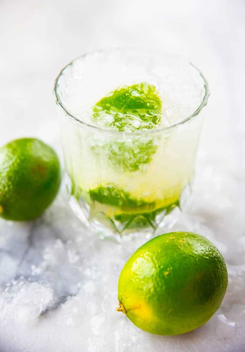 close up glass of Caipirinha with crushed ice, garnish with lime