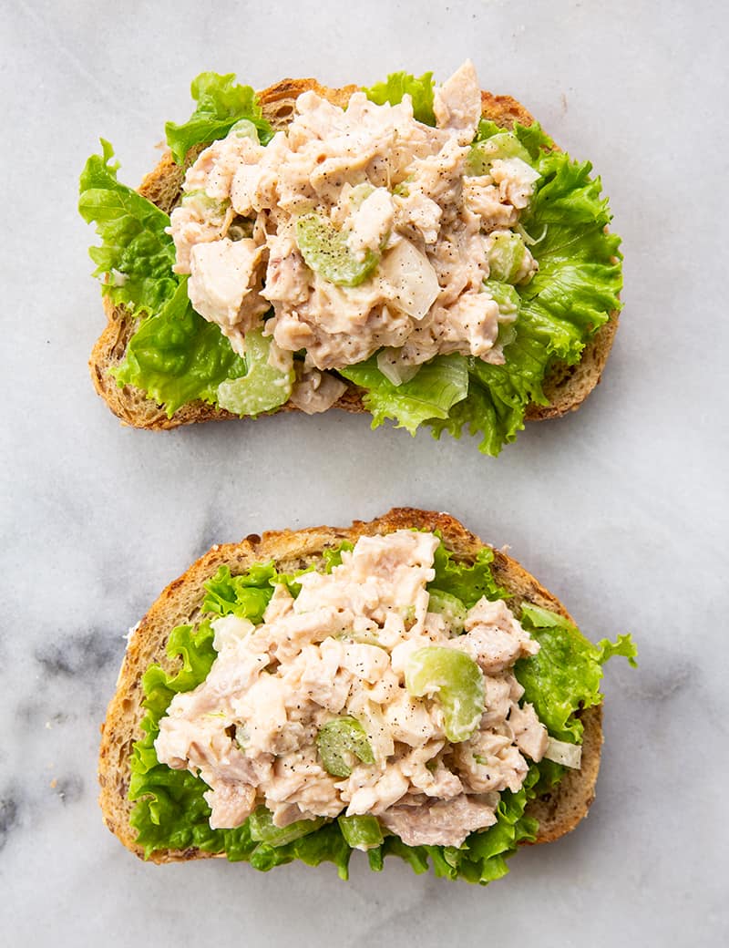 chicken salad on two pieces of bread with lettuce