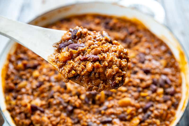 large wooden spoon full of cowboy beans