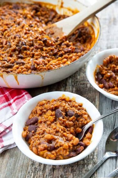 some serving of Cowboy Beans in white small plates