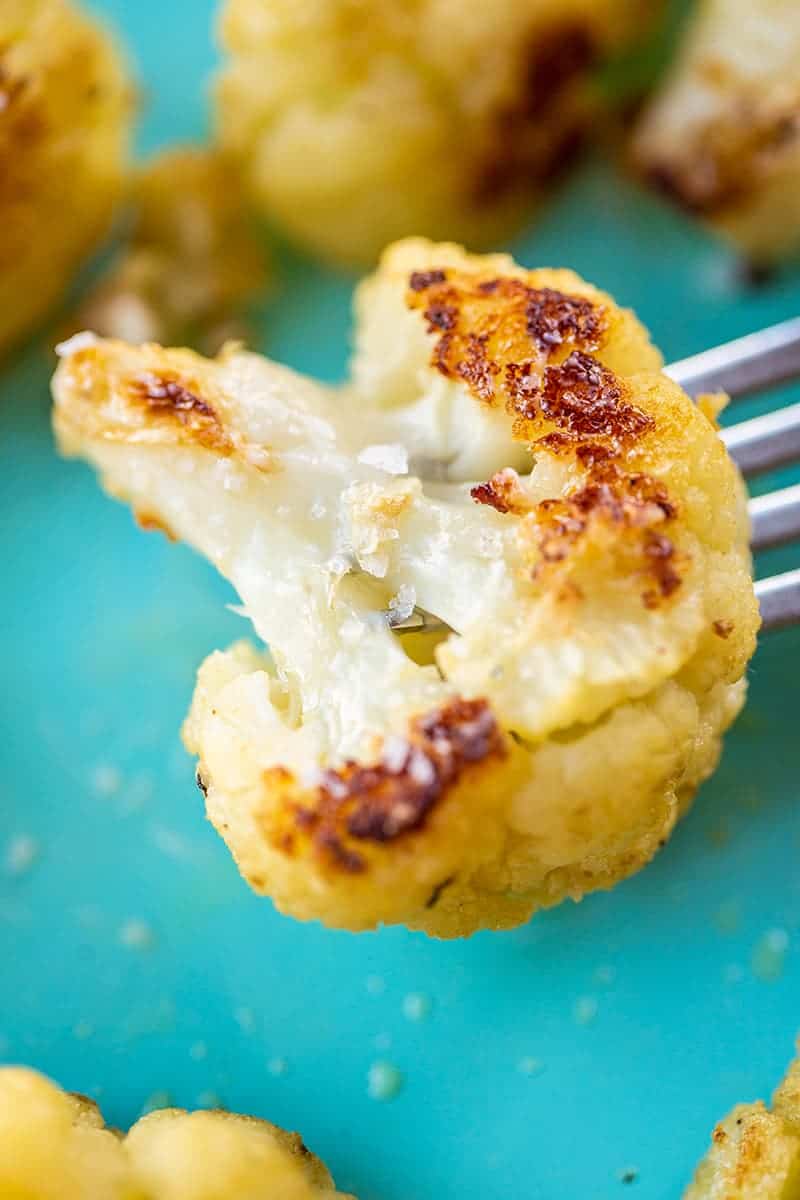Buttery Garlic Roasted Cauliflower florets on a fork
