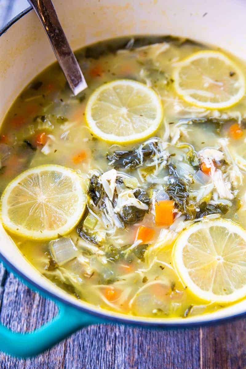 close up Lemon Chicken Soup with Orzo in a large blue pot