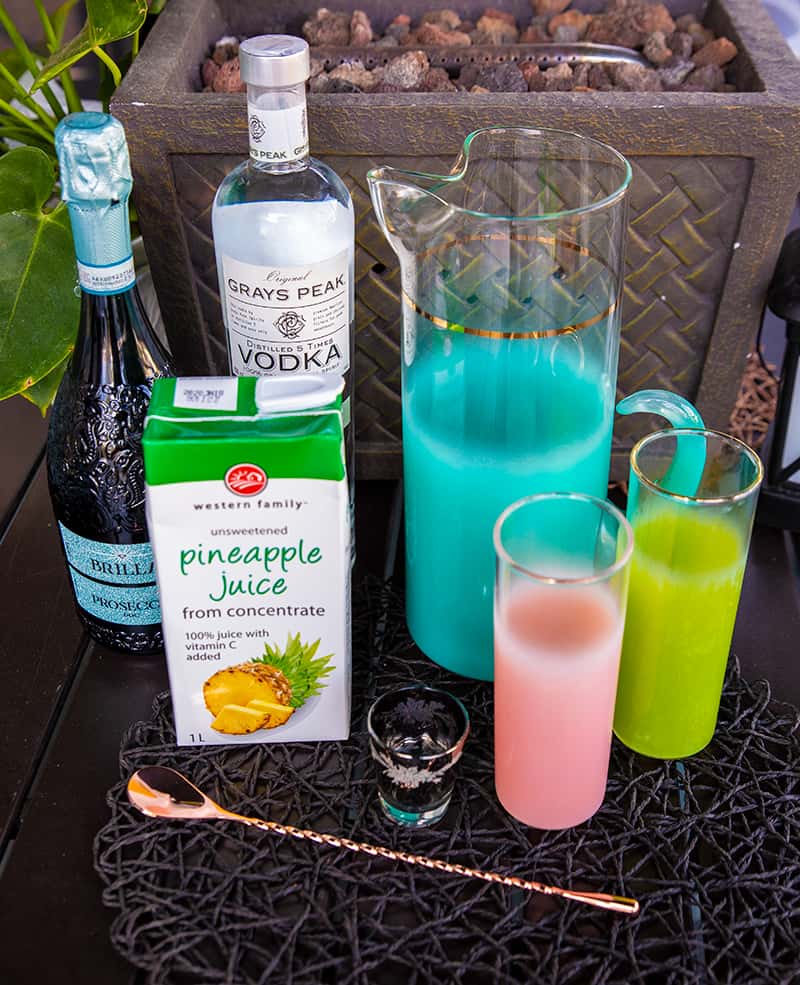 Pineapple Prosecco Punch ingredients - box of Pineapple juice, bottle of Prosecco and vodka