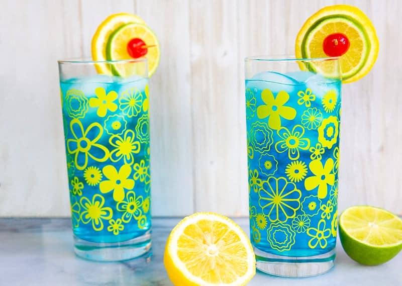 glasses filled with Electric Lemonade garnish with a slices of lemon and lime