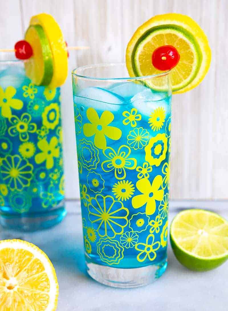 Two Electric Lemonade cocktails side by side in vintage flower glasses