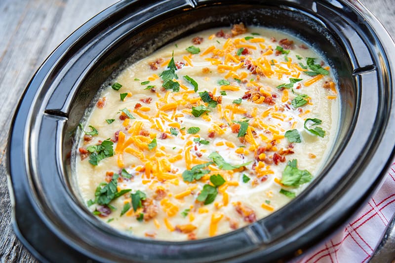 cauliflower leek soup in a black slow cooker