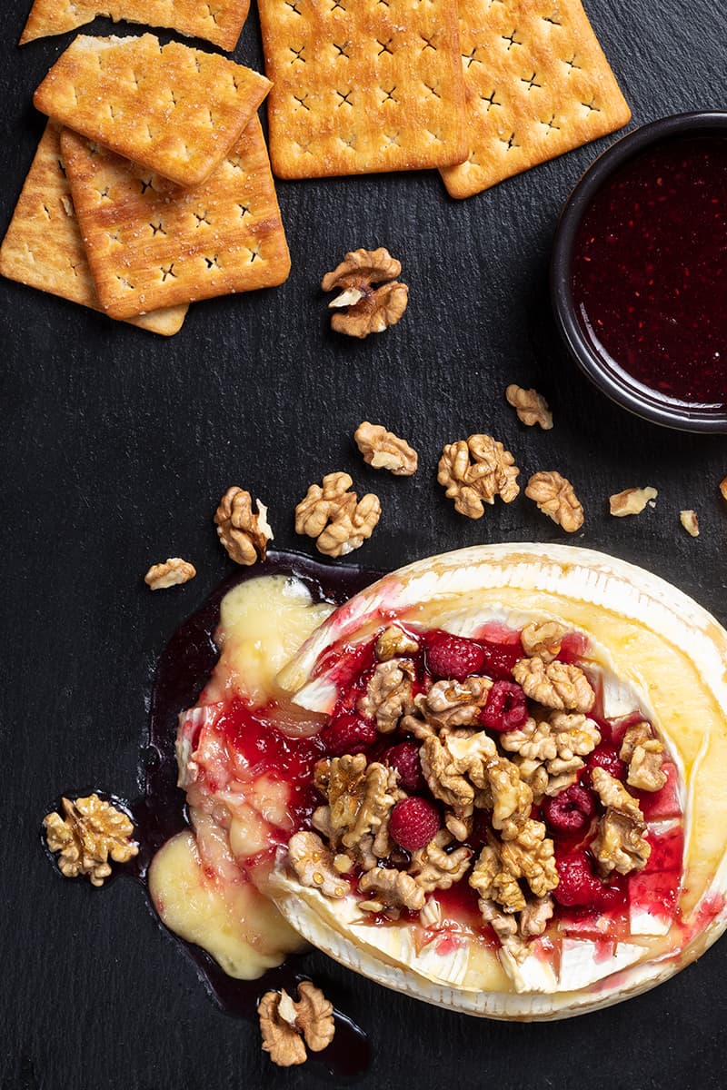 Walnut Raspberry Baked Brie with some extra crackers and bread crisps